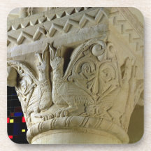Column capital bearing symmetrically arranged grot drink coasters