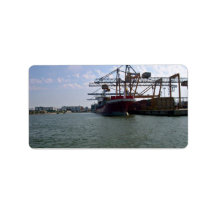 Container ships stacked in port against blue sky custom address label