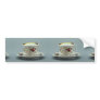 Cup and saucer with colorful flower designs on it. bumper stickers