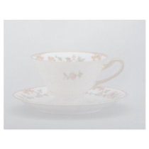 Cup and saucer with colourful flowers on it. personalized letterhead