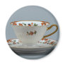 Cup and saucer with colourful flowers on it. fridge magnet
