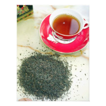 Cup of black tea with tea leaves photo