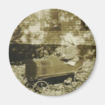 cute little girl in peddle car round magnet