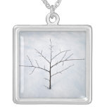 Dried branch lonely tree on a snowy landscape jewelry