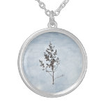 Dry branches tree sticking out of the snow necklace
