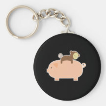 Équitation de singe de bébé sur un porc porte-clefs