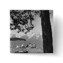 Family having picnic by lake mountains pins