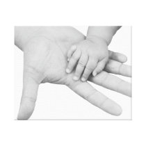 Father holding his baby hand stretched canvas print