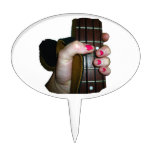 Female hand holding four string bass neck cake picks