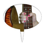 female hand holding four string bass neck cake picks
