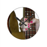 female hand holding four string bass neck wall clocks