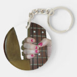 female hand holding four string bass neck acrylic keychain