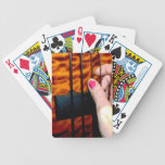 female hand pulling bass string 1 posterized playing cards