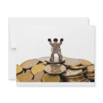 Figurine on top of a pile of coins custom announcements