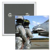 Firefighters deploy a fire hose during a drill pinback buttons