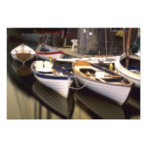 Fog surrounds four boats docked.