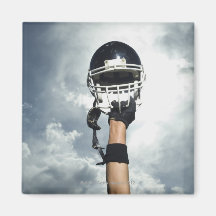 Football player holding helmet in air refrigerator magnet