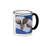 Football players huddled together mugs