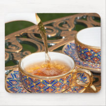 Golden cup of tea mousepads