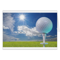golf ball on a tee with grass cards