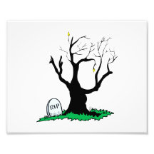 Gravestone dead tree big trunk. photograph