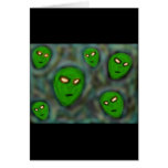 green aliens with glowing eyes murky background card