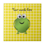 Green frog on yellow argyle tile