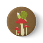 Green snail on red speckled mushrooms buttons