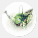 green watering can with bird stickers