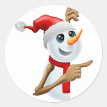 Happy snowman in Santa hat pointing Round Stickers