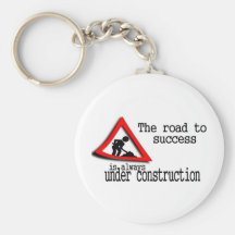 La route au succès est toujours en construction porte-clés