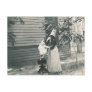 lady with bonnet putting child on seat post card