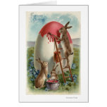 Lapins peignant un oeuf carte de vœux