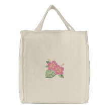 Les fleurs jaunes roses de ketmie ont brodé le sac