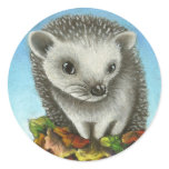 Little hedgehog on a big pile of leaves round stickers