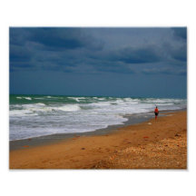 Lone Man Walking on Stormy Beach Photograph