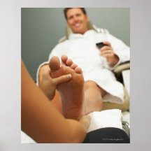 Low angle view of man receiving foot massage posters