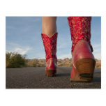 Low-angle view of woman wearing cowboy boots post card