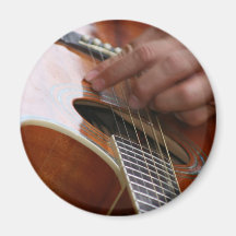 male hand holding pick on acoustic guitar refrigerator magnet