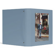 Man Crossing Street With Bicycle Binders