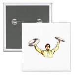 Man holding up cymbals yellow shirt pins