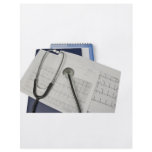 medical stethoscope on cardiogram EKG readings flyers