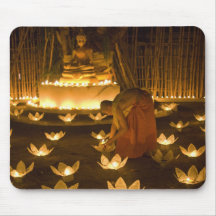 Monks lighting khom loy candles and lanterns for mousepads