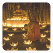 Monks lighting khom loy candles and lanterns for square stickers
