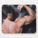 Muscular man flexing mouse pad