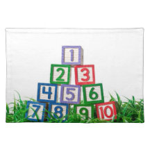 Number blocks stacked on grass placemats