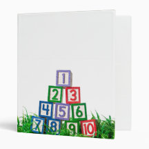Number blocks stacked on grass vinyl binders