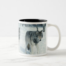 Pack of wolves at edge of snowy forest coffee mugs