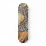 Pebbles On The Beach With A Tiny Crab Skateboard