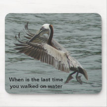 Pelican walking on water mousepads
